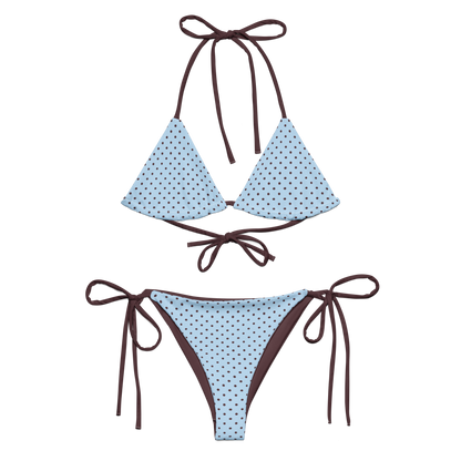 Blue polka dot bikini with brown straps on a white background