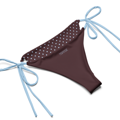 Brown bikini bottom with light blu polka dots and blue strings on a white background