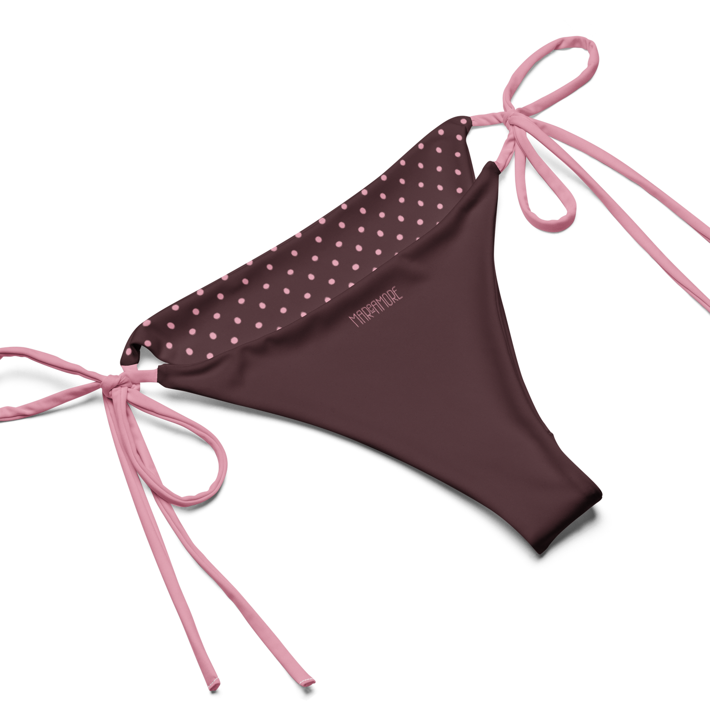 Brown bikini bottom with pink polka dot top and pink strings on a white background