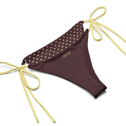 Brown bikini bottom with yellow polka dots and matching strings on a white background