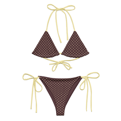 Brown bikini set with white polka dots and yellow strings on a white background