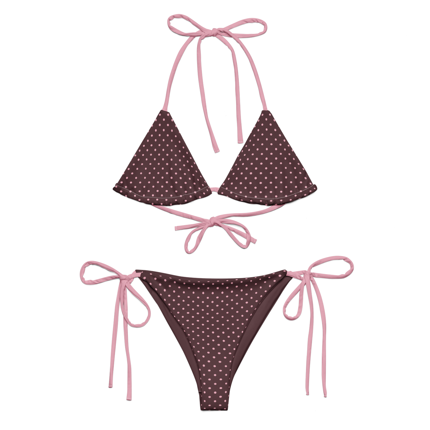 Pink polka dot bikini set with pink strings on a brown background