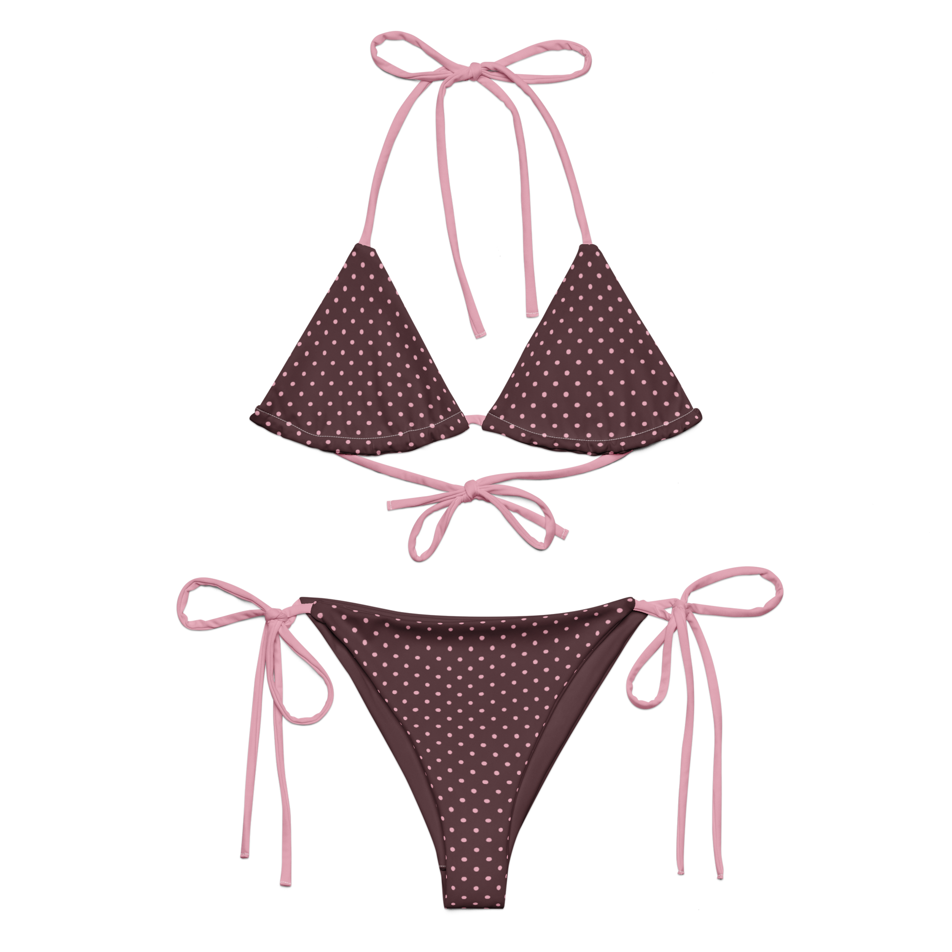 Pink polka dot bikini set with pink strings on a brown background